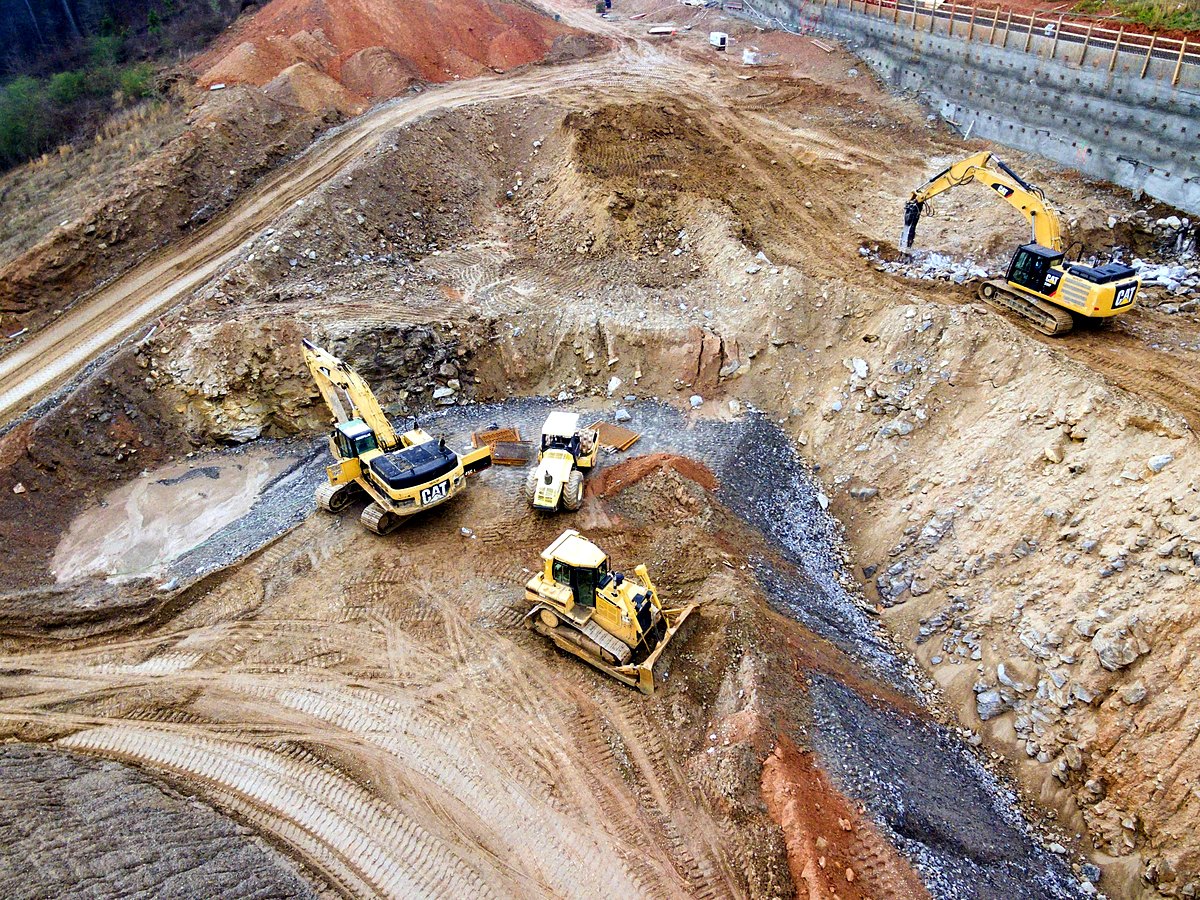 Aerial view of excavators and a bulldozer on an aggregates site