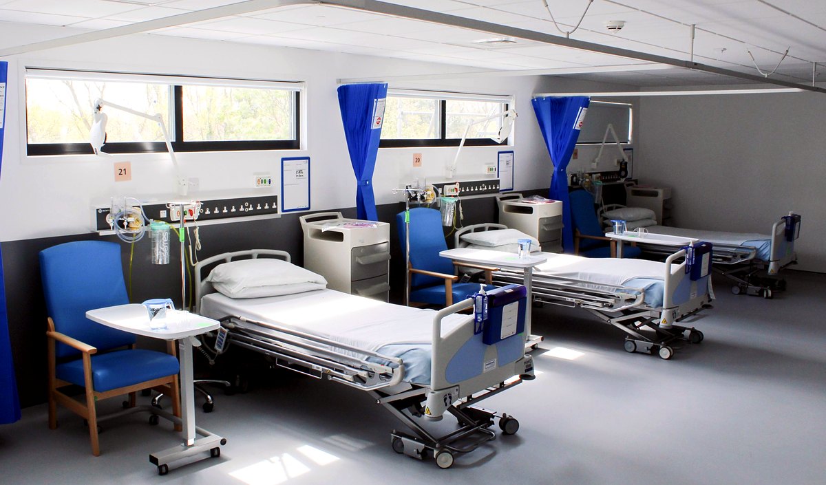 Hospital ward with beds and medical equipment
